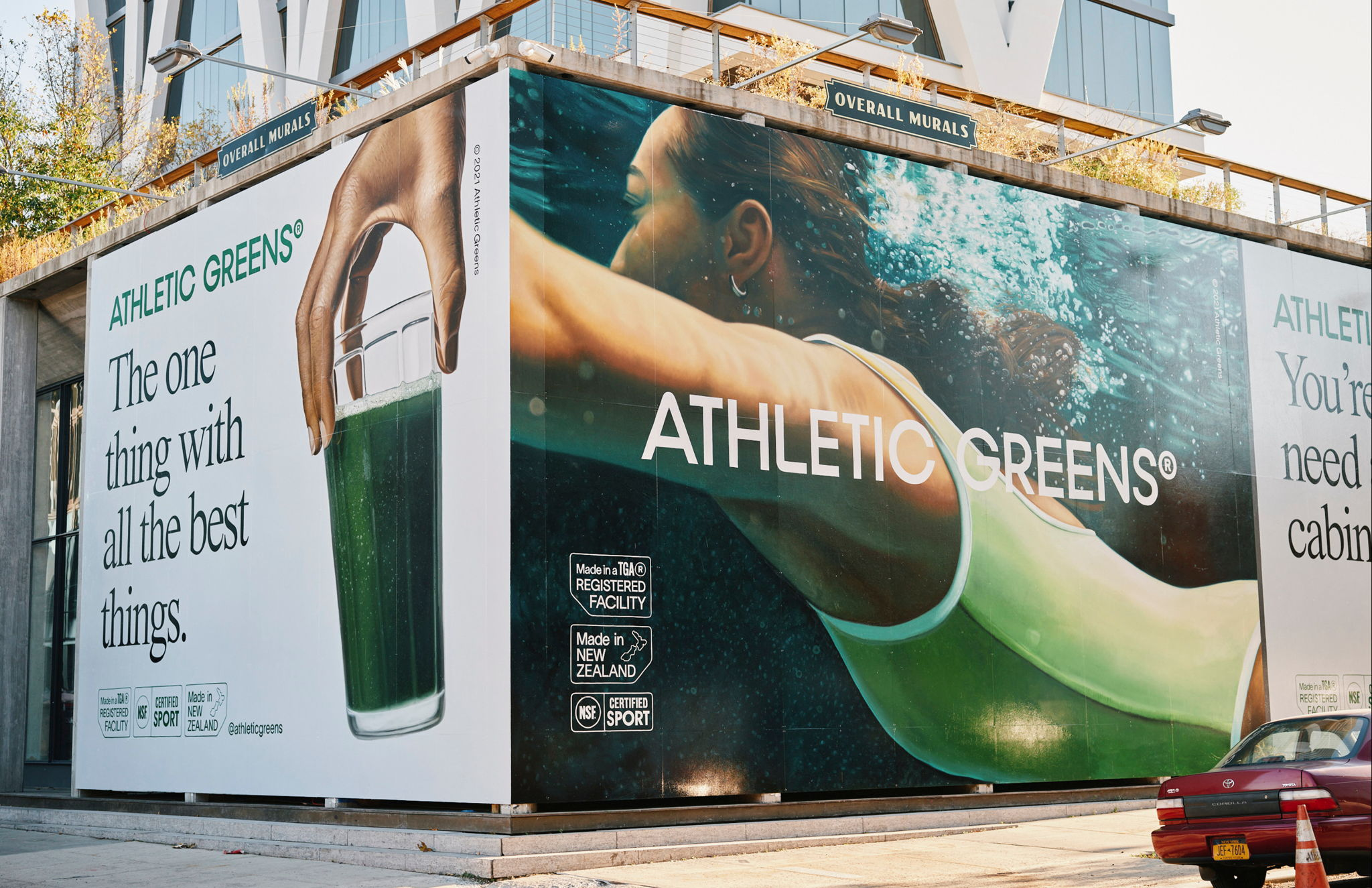 Print ad of Athletic Greens, one side shows someone picking up a glass with the text "the one thing with all the best things" and the other side shows a woman swimming.