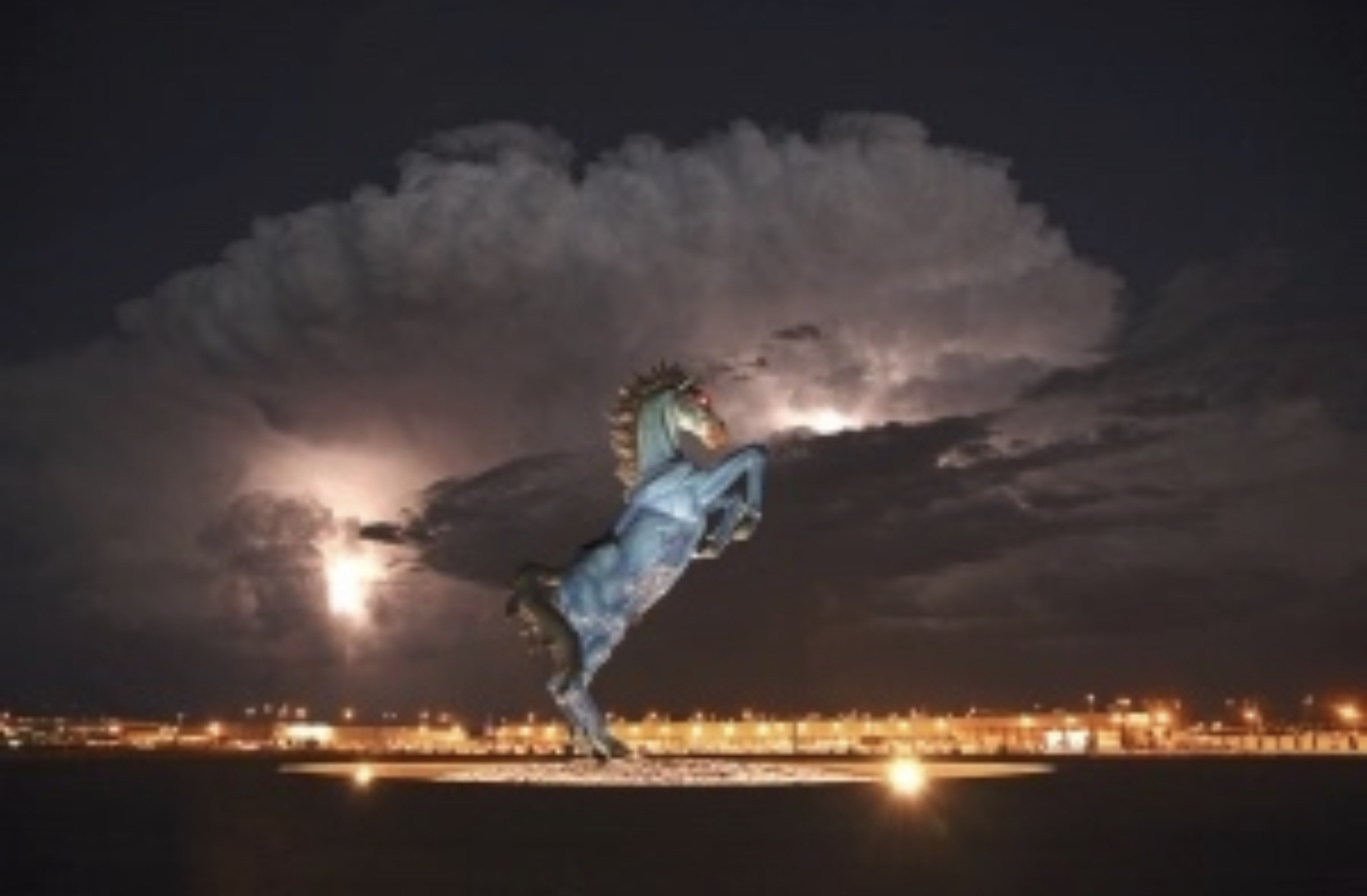 Giant blue horse statue with glowing red eyes outside of Denver International Airport