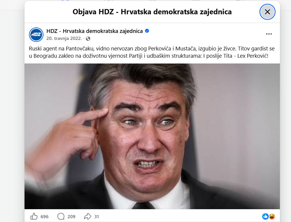 A screenshot of a Facebook post by the political party "HDZ - Hrvatska demokratska zajednica." The post features Croatian text above an unflattering close-up photograph of Zoran Milanović, who is making a strained facial expression while pointing his right index finger directly at his temple.