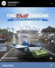An ad with a chair at a tailgate party, decorated with the Coors Light logo, the foot rest looks like a turf football field.  The chair has a beer tap and a Coors Light on each arm rest with a football stadium and mountains in the background.